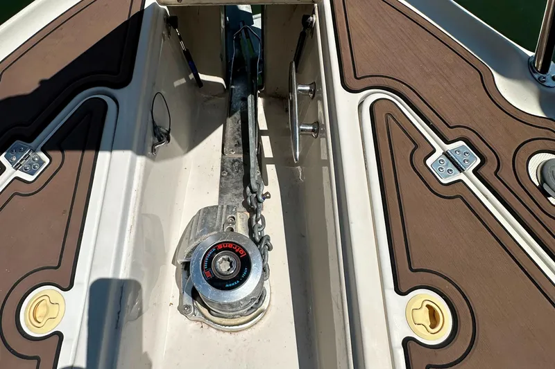 Slide: The Image of Anchor winch on 2001 Regal Commodore 3780 boat deck, featuring wood accents and metal fittings. - 27