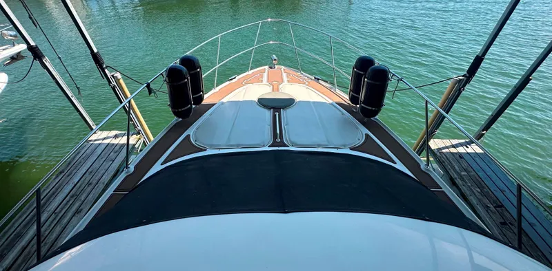 Slide: The Image of 2001 Regal Commodore 3780 yacht docked on calm water. - 23