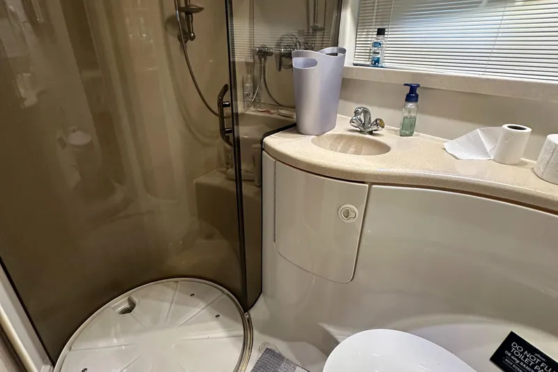 Slide: The Image of Compact bathroom in 2001 Regal Commodore 3780 yacht with shower and sink. - 48