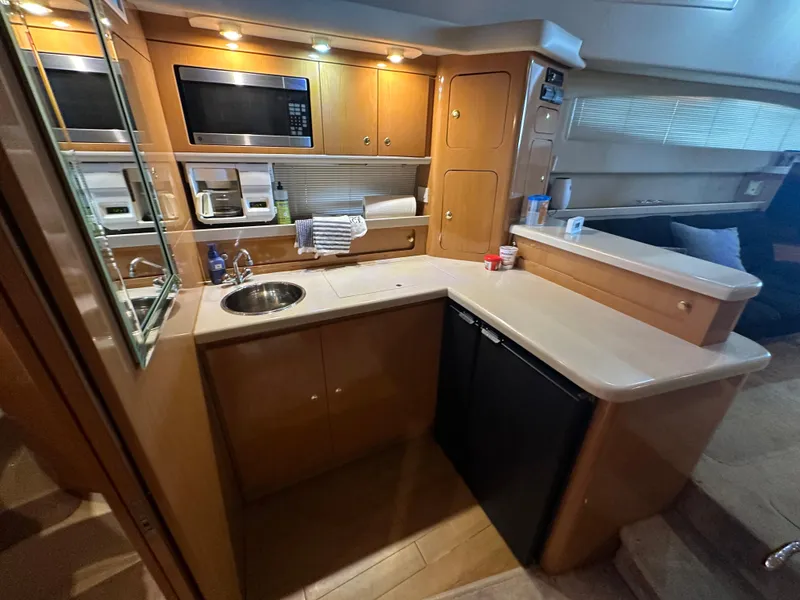 Slide: The Image of 2001 Regal Commodore 3780 yacht kitchen with modern appliances and wood cabinetry. - 45