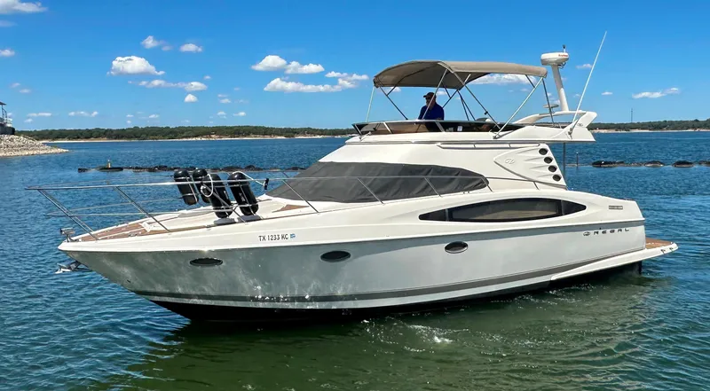 Slide: The Image of 2001 Regal Commodore 3780 yacht cruising on a sunny day. - 3