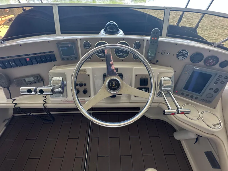 Slide: The Image of 2001 Regal Commodore 3780 helm with steering wheel, controls, and navigation instruments. - 17