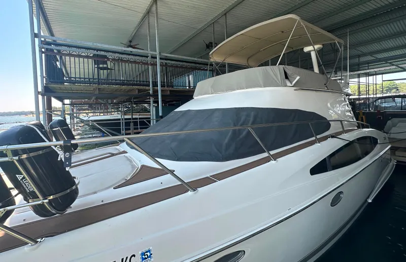 Slide: The Image of 2001 Regal Commodore 3780 yacht docked in covered marina. - 12