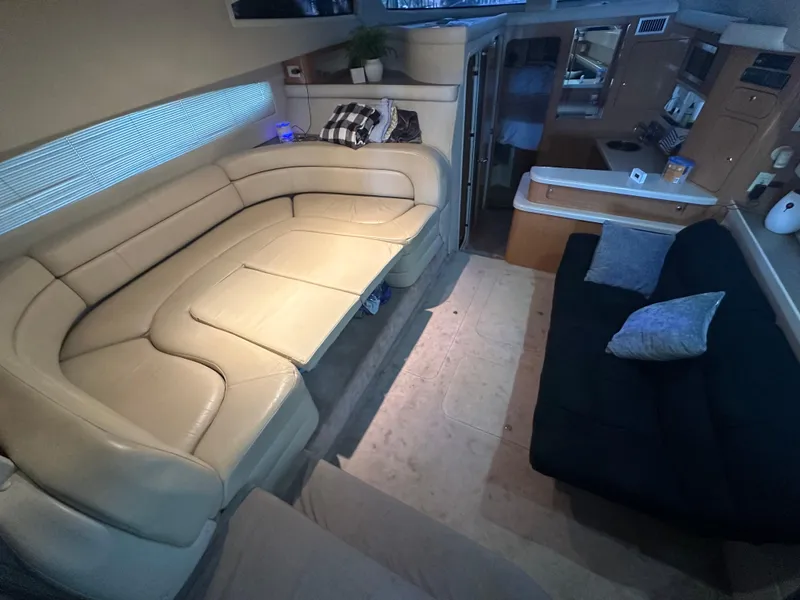 Slide: The Image of Interior of 2001 Regal Commodore 3780 yacht with beige and black seating. - 32