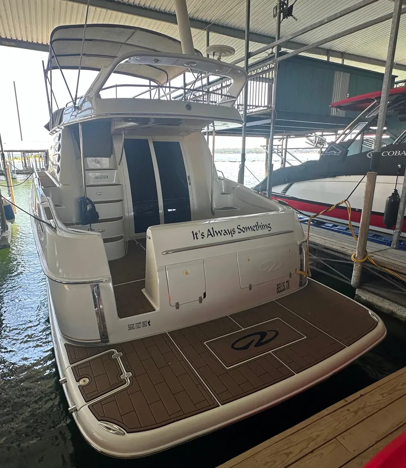 Slide: The Image of 2001 Regal Commodore 3780 yacht docked in marina, rear view. - 13