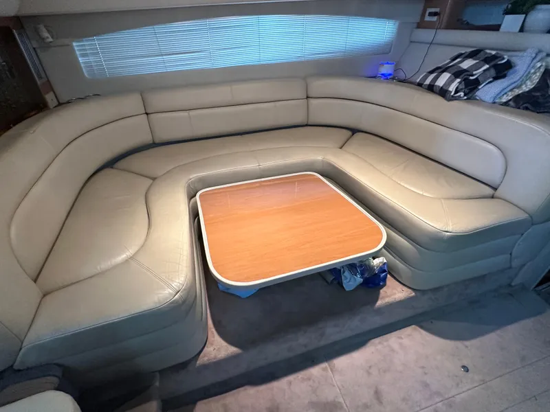 Slide: The Image of Luxurious interior of 2001 Regal Commodore 3780 with beige leather seating and wooden table. - 33