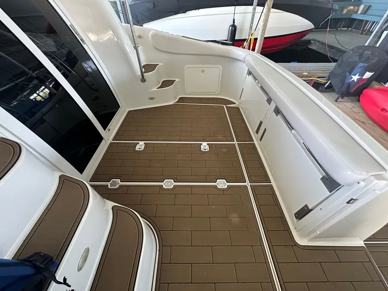Slide: The Image of 2001 Regal Commodore 3780 boat interior with brown flooring and white seating. - 15