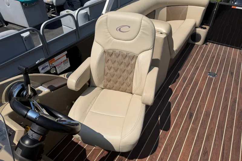 Slide: The Image of Captain's chair on 2019 Crest II 230 SL pontoon boat with wood-style flooring. - 7