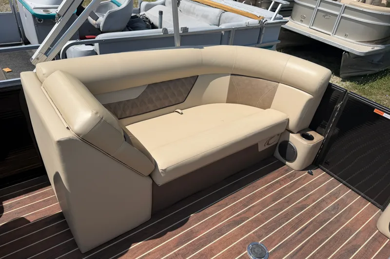 Slide: The Image of Luxurious seating on a 2019 Crest II 230 SL pontoon boat with beige upholstery. - 10