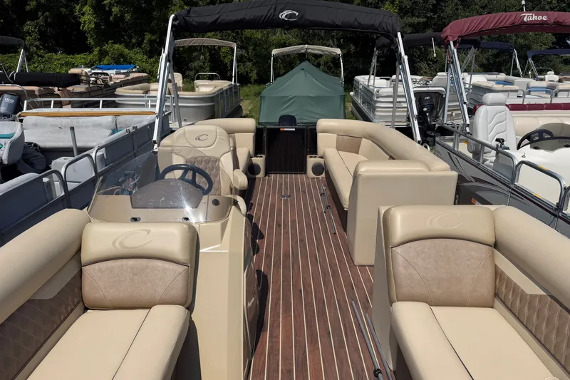 Slide: The Image of 2019 Crest II 230 SL pontoon boat with beige seating and wood-style flooring. - 3
