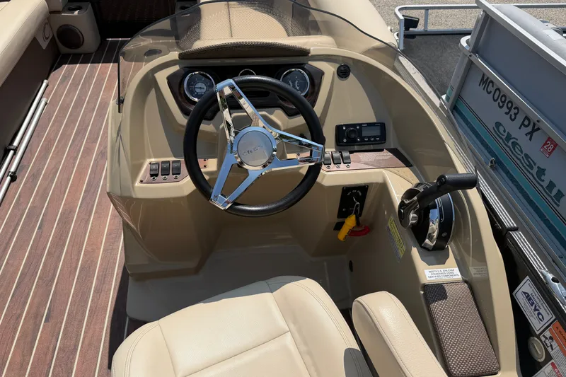Slide: The Image of 2019 Crest II 230 SL boat dashboard with steering wheel and controls. - 8