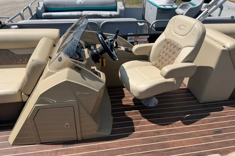 Slide: The Image of 2019 Crest II 230 SL boat interior with beige captain's chair and steering console. - 6