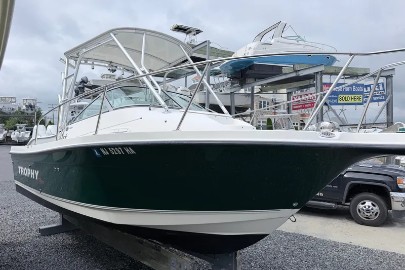 Slide: The Image of 2007 Trophy 2002 Walkaround boat displayed at a dealership, showcasing sleek design and structure. - 2