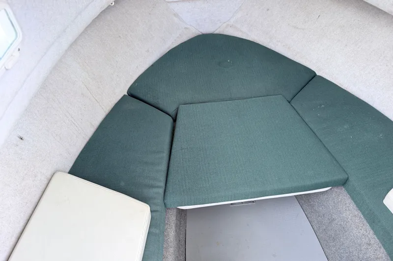 Slide: The Image of 2007 Trophy 2002 Walkaround cabin interior with green cushions and white walls. - 13