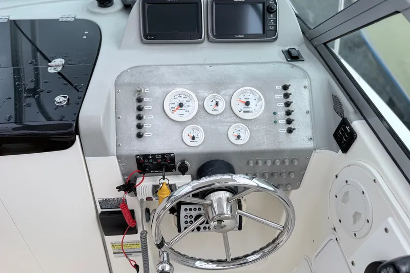 Slide: The Image of Dashboard of a 2007 Trophy 2002 Walkaround boat with gauges and steering wheel. - 11