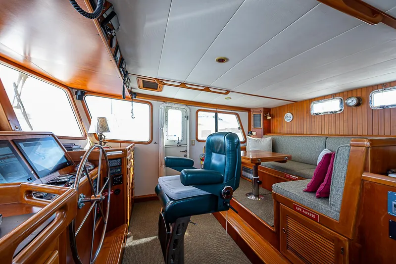 Slide: The Image of Interior of 2001 Kadey-Krogen 58 yacht with helm, seating, and navigation equipment. - 18