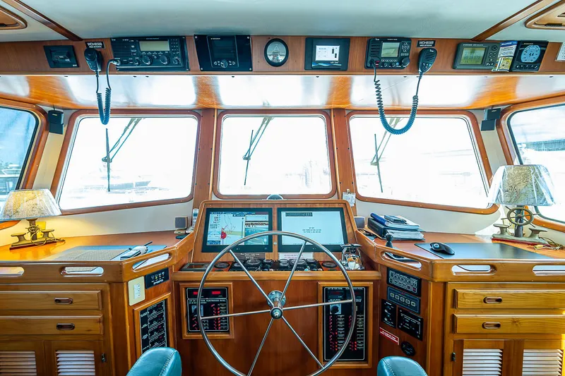 Slide: The Image of Pilothouse of 2001 Kadey-Krogen 58 yacht with navigation equipment and wooden interior. - 19