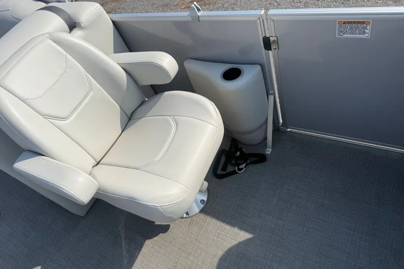 Slide: The Image of 2024 Sylvan Mirage 820 LZ boat interior with plush seating and cup holder. - 16