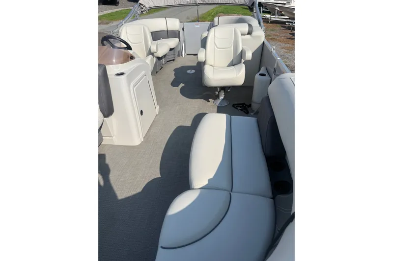 Slide: The Image of 2024 Sylvan Mirage 820 LZ pontoon boat interior with plush seating and helm. - 7