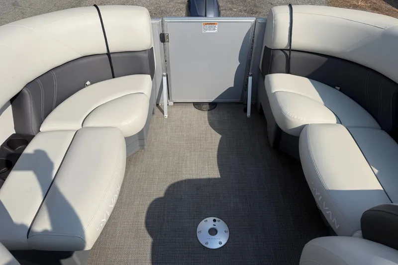 Slide: The Image of 2024 Sylvan Mirage 820 LZ boat interior with plush seating and carpeted floor. - 11