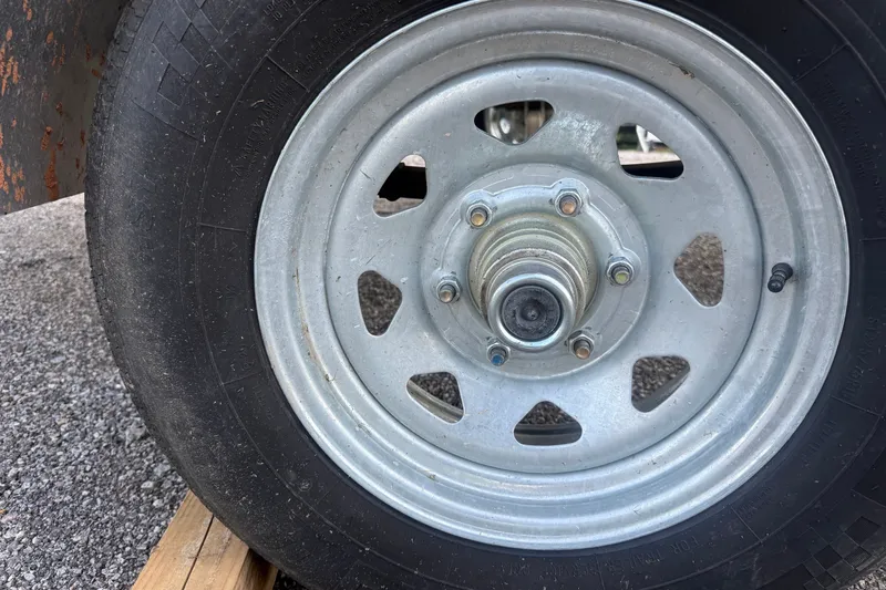 Slide: The Image of Close-up of a 2024 Sylvan Mirage 820 LZ trailer wheel on asphalt. - 20