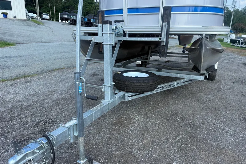 Slide: The Image of 2024 Sylvan Mirage 820 LZ pontoon boat on trailer, parked outdoors. - 18