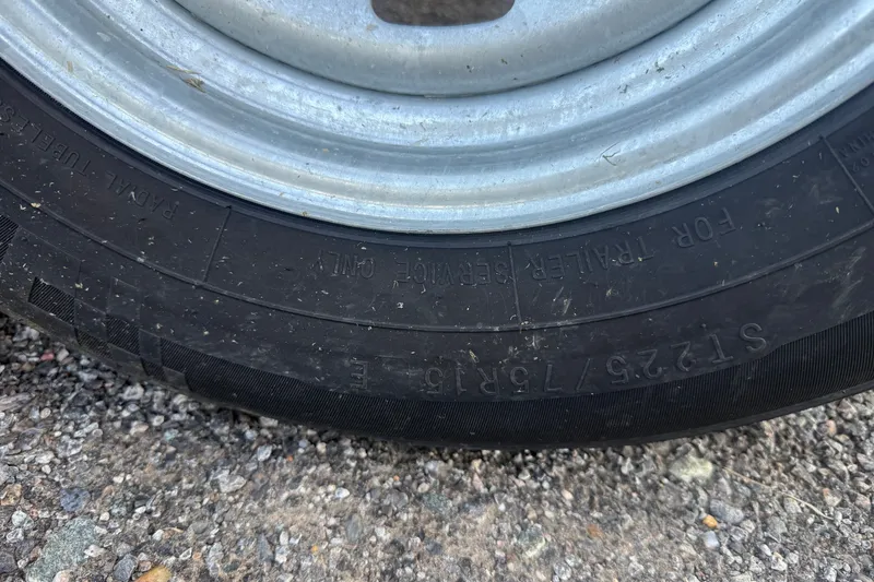 Slide: The Image of Close-up of a tire on a 2024 Sylvan Mirage 820 LZ trailer. - 21