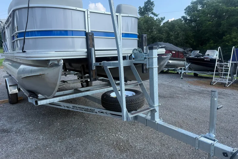 Slide: The Image of 2024 Sylvan Mirage 820 LZ pontoon boat on a trailer in a parking area. - 19