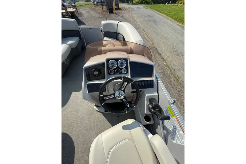 Slide: The Image of 2024 Sylvan Mirage 820 LZ boat dashboard with steering wheel and control panel. - 13