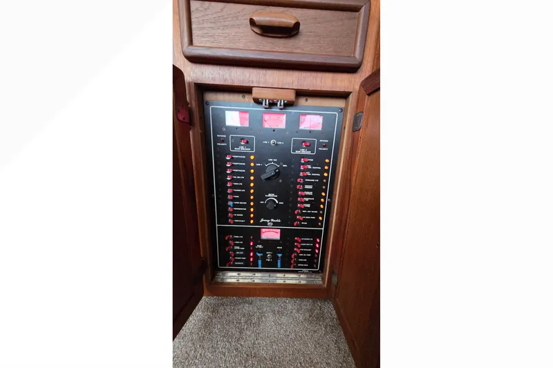 Slide: The Image of Control panel of a 1989 Jersey 42 Convertible Sportfisherman boat, featuring switches and indicators. - 23
