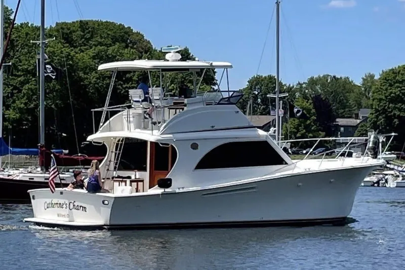 The Image of 1989 Jersey 42 Convertible Sportfisherman boat cruising on a sunny day in a marina. - 0