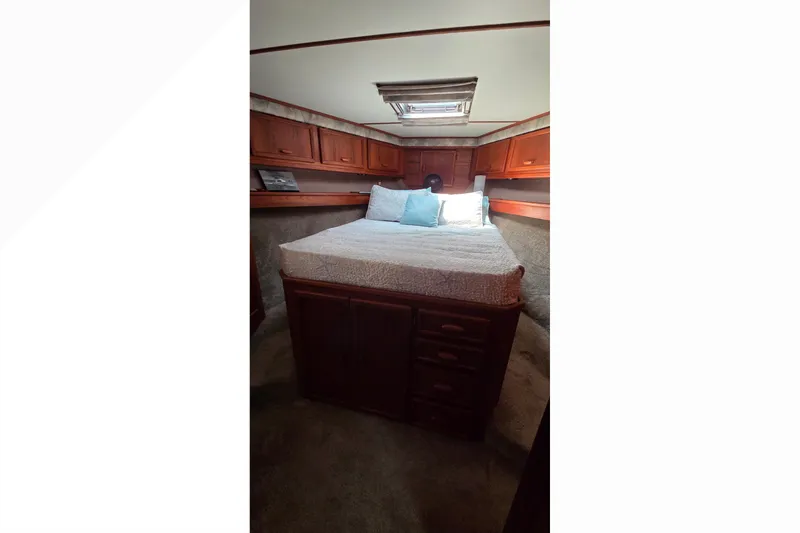Slide: The Image of Cozy cabin interior of 1989 Jersey 42 Convertible Sportfisherman with wood cabinetry and skylight. - 12