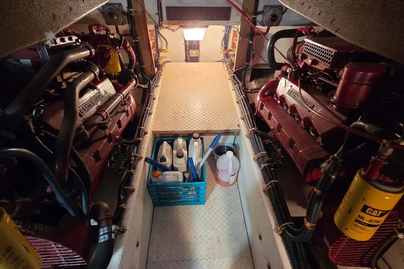 Slide: The Image of Engine room of 1989 Jersey 42 Convertible Sportfisherman with Caterpillar engines and maintenance supplies. - 24