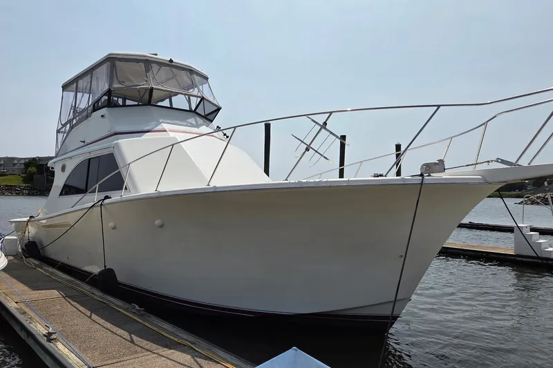 Slide: The Image of 1989 Jersey 42 Convertible Sportfisherman docked at marina, showcasing sleek design and spacious deck. - 3