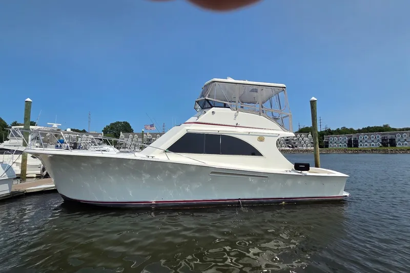 Slide: The Image of 1989 Jersey 42 Convertible Sportfisherman docked in a marina under clear blue skies. - 1