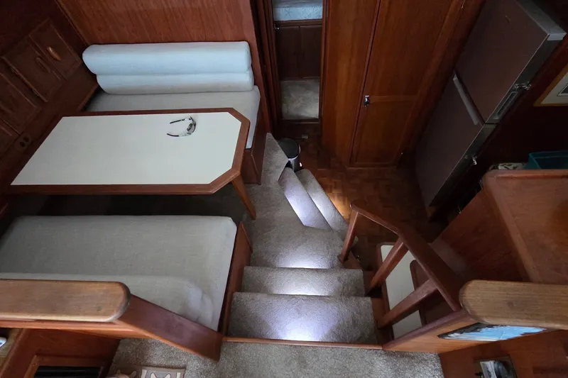 Slide: The Image of Interior of 1989 Jersey 42 Convertible Sportfisherman with stairs, dining area, and wood finishes. - 9