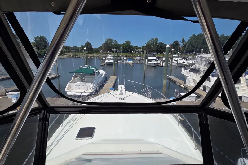 Slide: The Image of 1989 Jersey 42 Convertible Sportfisherman docked at a marina, view from the helm. - 19
