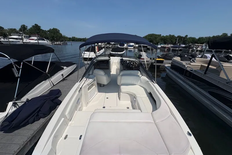 Slide: The Image of 2005 Regal 2600 LSR boat docked at a marina, featuring spacious seating and canopy. - 3