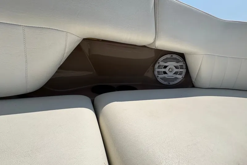 Slide: The Image of 2005 Regal 2600 LSR boat interior with speaker and cushioned seating. - 8