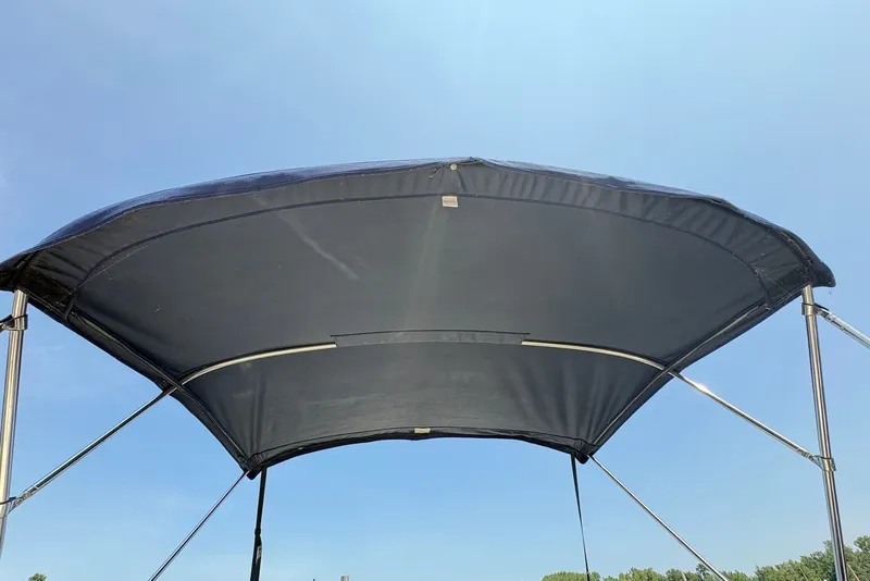 Slide: The Image of Bimini top of a 2005 Regal 2600 LSR boat against a clear blue sky. - 4