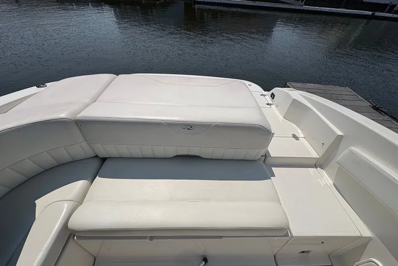 Slide: The Image of 2005 Regal 2600 LSR boat interior with white seating by the water. - 6
