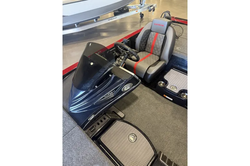 Slide: The Image of 2027 Caymas 201 Pro boat interior with sleek steering and comfortable seating. - 2
