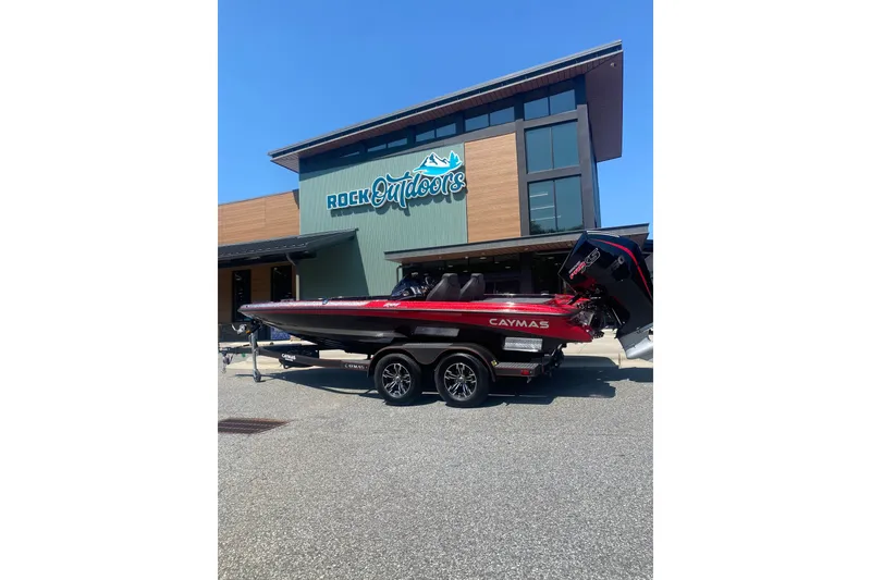 The Image of 2027 Caymas 201 Pro boat parked outside Rock Outdoors store. - 0