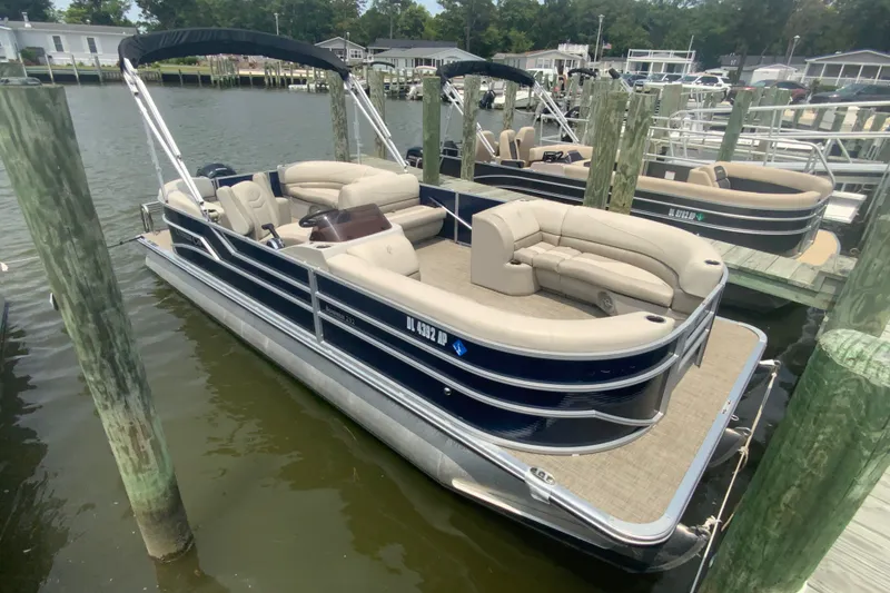Slide: The Image of 2023 Cypress Cay Seabreeze 232 pontoon boat docked at marina. - 2