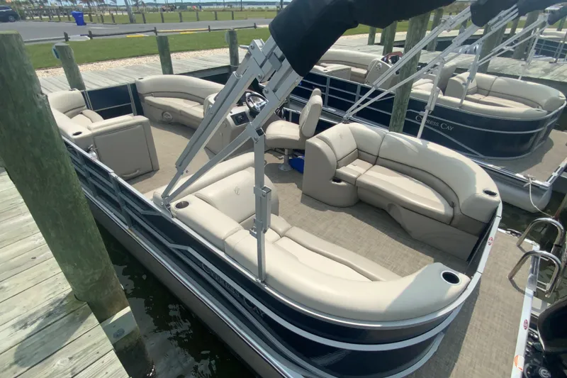 Slide: The Image of 2023 Cypress Cay Seabreeze 232 pontoon boat docked, featuring spacious seating and modern design. - 3