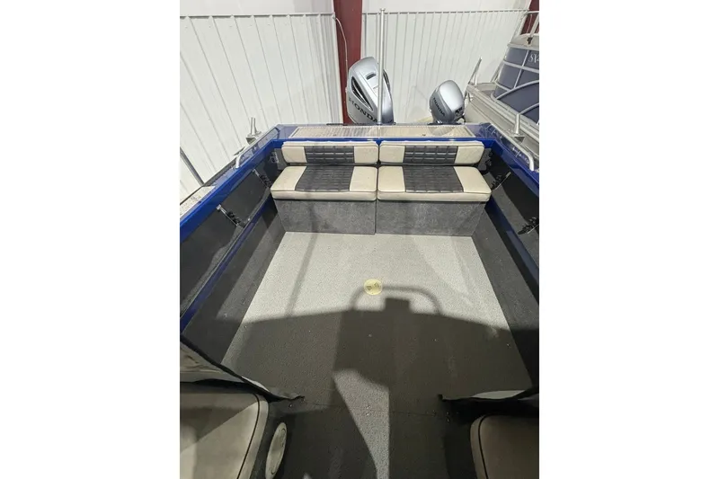 Slide: The Image of 2013 Northwest Boats 228 Lightning Outboard interior with cushioned seating and dual outboard motors. - 11