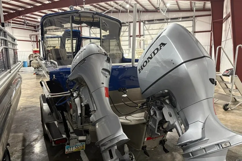 Slide: The Image of 2013 Northwest Boats 228 Lightning Outboard with dual Honda engines in a storage facility. - 9