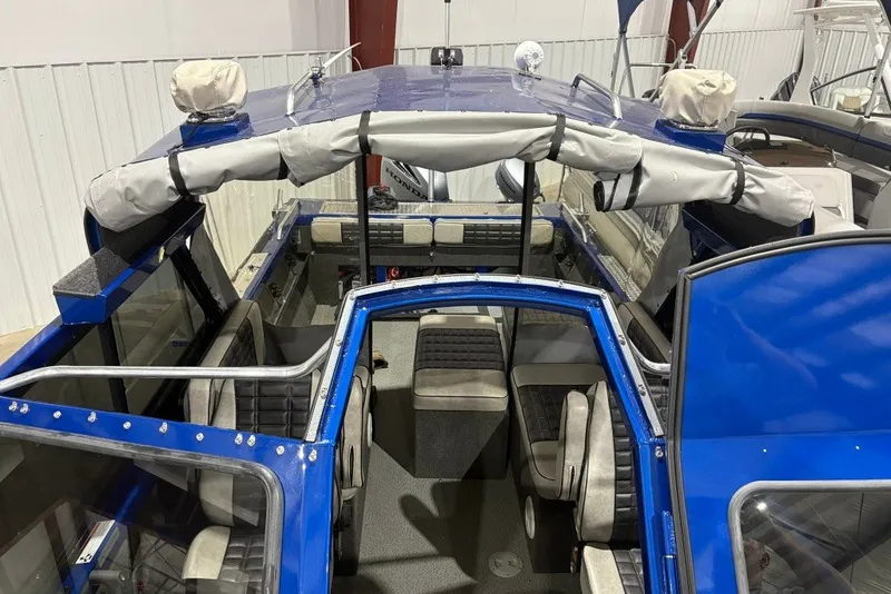 Slide: The Image of 2013 Northwest Boats 228 Lightning Outboard interior, featuring blue exterior and spacious seating. - 13