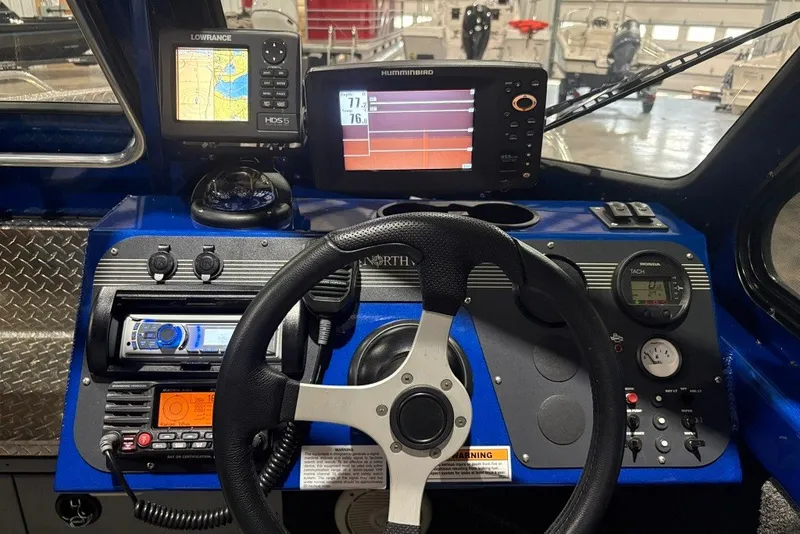Slide: The Image of 2013 Northwest Boats 228 Lightning Outboard dashboard with navigation and control systems. - 17