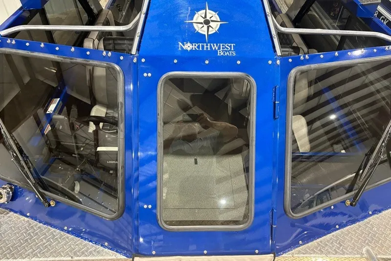 Slide: The Image of 2013 Northwest Boats 228 Lightning Outboard, blue exterior, top view of cabin and seating. - 6